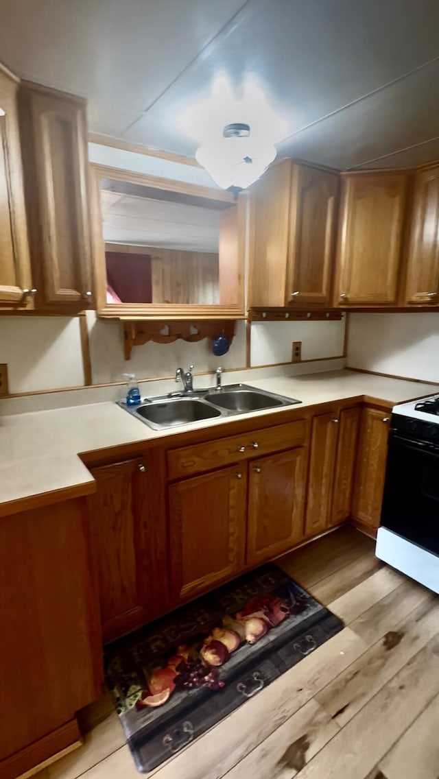 2833 S Horseshoe Trl, Grayling, MI 49738 - kitchen featuring electric range, light wood-style floors, light countertops, and brown cabinetry