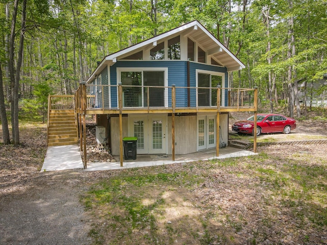 18680 Red Pine Dr, Hillman, MI 49746 - rear view of property with french doors, stairway, a wooden deck, and a patio area