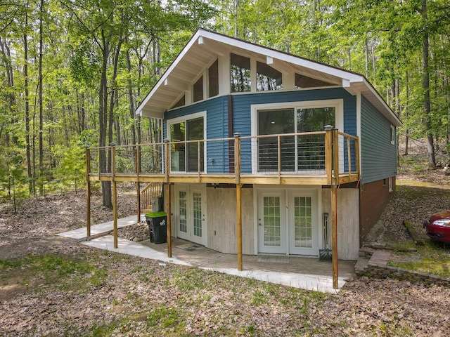 18680 Red Pine Dr, Hillman, MI 49746 - rear view of property with french doors, a patio area, and a deck