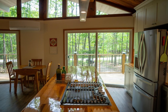 18680 Red Pine Dr, Hillman, MI 49746 - dining space with a wall mounted AC, dark wood-type flooring, and wood ceiling