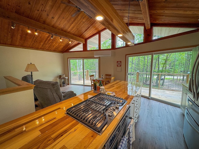 18680 Red Pine Dr, Hillman, MI 49746 - kitchen with a wall unit AC, wooden ceiling, stainless steel gas cooktop, wood finished floors, and wall oven