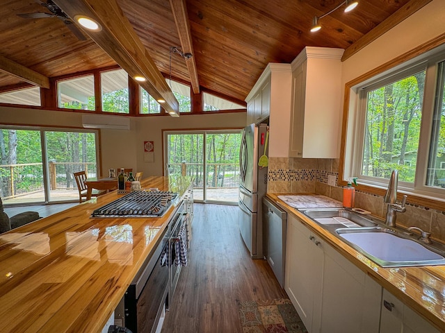 18680 Red Pine Dr, Hillman, MI 49746 - kitchen featuring stainless steel appliances, wood ceiling, white cabinets, wooden counters, and dark wood-style floors