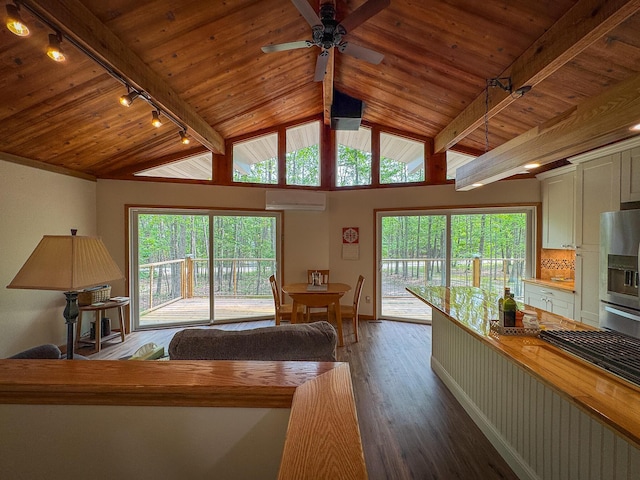 18680 Red Pine Dr, Hillman, MI 49746 - living room featuring rail lighting, an AC wall unit, wood finished floors, wood ceiling, and a ceiling fan