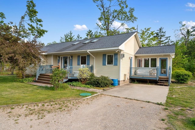 10134 Upper Mograin Rd, Cheboygan, MI 49721 - ranch-style house with a wooden deck, dirt driveway, a front yard, and a shingled roof