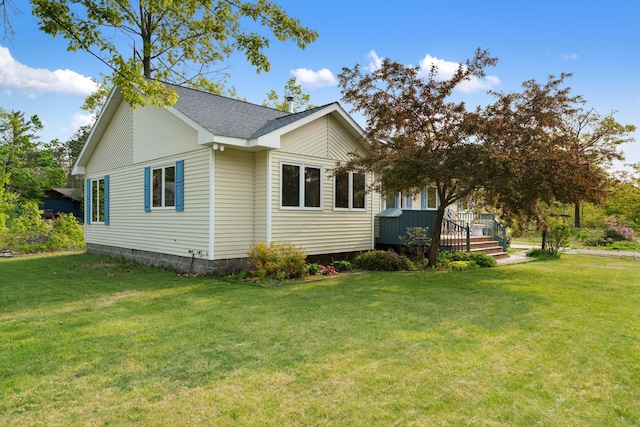 10134 Upper Mograin Rd, Cheboygan, MI 49721 - view of side of home featuring a lawn, a deck, and a shingled roof