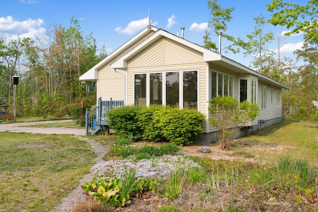 10134 Upper Mograin Rd, Cheboygan, MI 49721 - view of side of home with a lawn