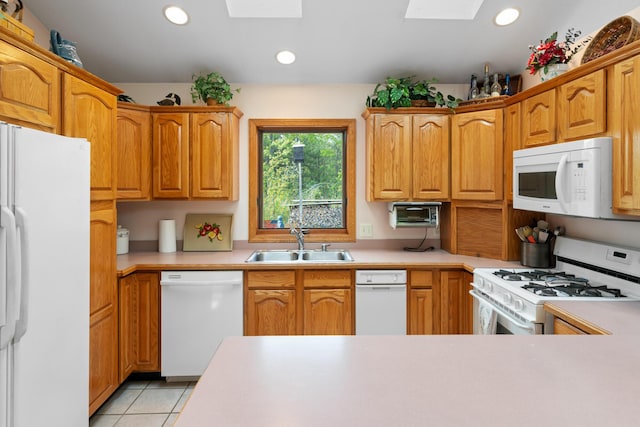10134 Upper Mograin Rd, Cheboygan, MI 49721 - kitchen featuring white appliances, a skylight, light countertops, and recessed lighting