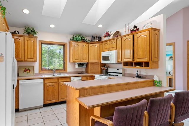 10134 Upper Mograin Rd, Cheboygan, MI 49721 - kitchen with white appliances, a skylight, a peninsula, light countertops, and a breakfast bar