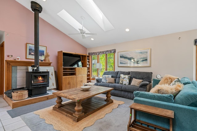 10134 Upper Mograin Rd, Cheboygan, MI 49721 - living room featuring a wood stove, a skylight, high vaulted ceiling, ceiling fan, and recessed lighting