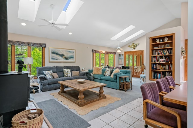 10134 Upper Mograin Rd, Cheboygan, MI 49721 - living room with a skylight, vaulted ceiling, plenty of natural light, light carpet, and light tile patterned floors