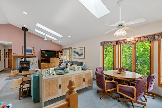 10134 Upper Mograin Rd, Cheboygan, MI 49721 - dining space with a skylight, lofted ceiling, a wood stove, ceiling fan, and recessed lighting
