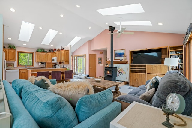 10134 Upper Mograin Rd, Cheboygan, MI 49721 - living room with a skylight, a wood stove, recessed lighting, and high vaulted ceiling