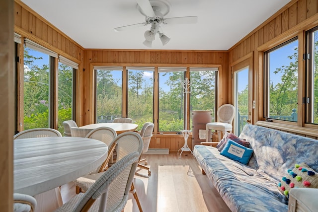 10134 Upper Mograin Rd, Cheboygan, MI 49721 - sunroom with healthy amount of natural light, wood walls, a ceiling fan, outdoor dining area, and crown molding