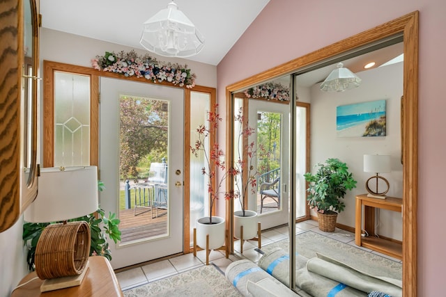 10134 Upper Mograin Rd, Cheboygan, MI 49721 - doorway to outside with light tile patterned floors, plenty of natural light, vaulted ceiling, and a chandelier