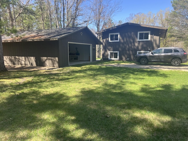 268 Yorke Trl, Grayling, MI 49738 - back of house with an outbuilding, a detached garage, and a lawn
