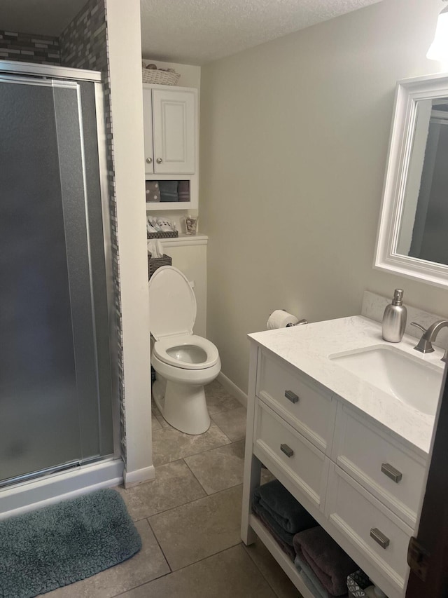 268 Yorke Trl, Grayling, MI 49738 - full bathroom with vanity, a stall shower, tile patterned flooring, washer / clothes dryer, and a textured ceiling