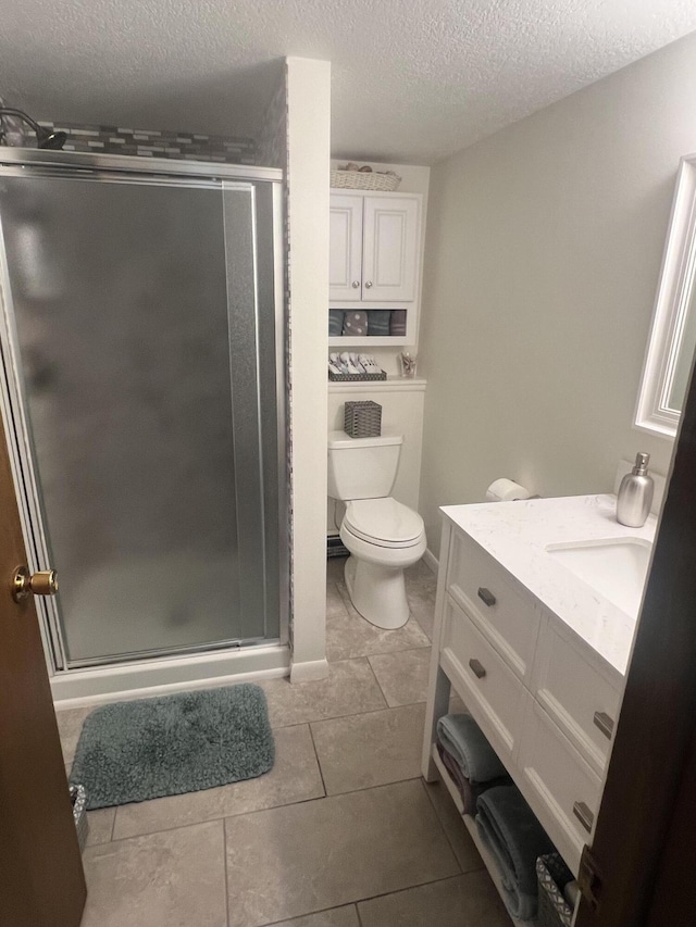 268 Yorke Trl, Grayling, MI 49738 - bathroom with a textured ceiling, vanity, a shower stall, and tile patterned floors