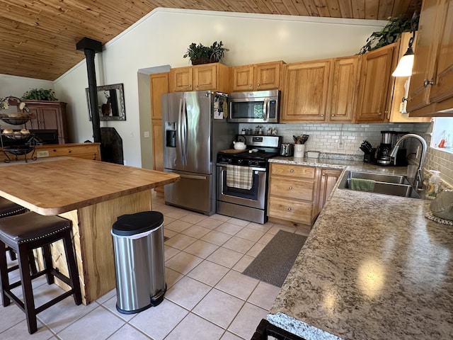 2131 Big Buck Dr, Lewiston, MI 49756 - kitchen featuring stainless steel appliances, wood ceiling, lofted ceiling, tasteful backsplash, and light tile patterned floors