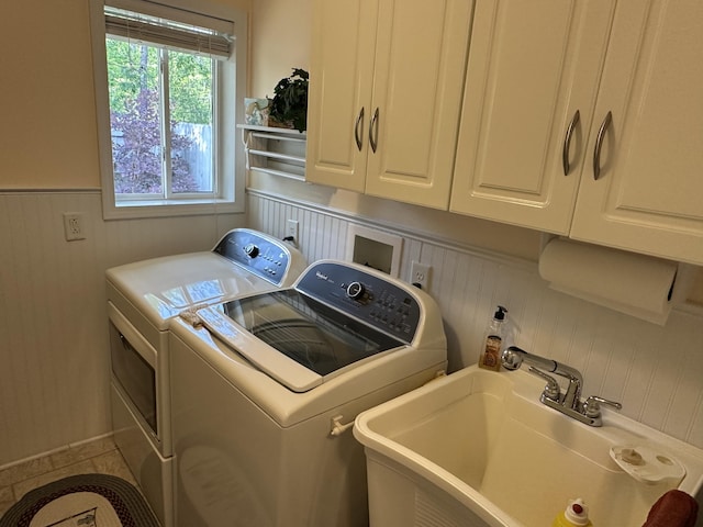 2131 Big Buck Dr, Lewiston, MI 49756 - laundry area with washing machine and dryer, cabinet space, wainscoting, and wood walls