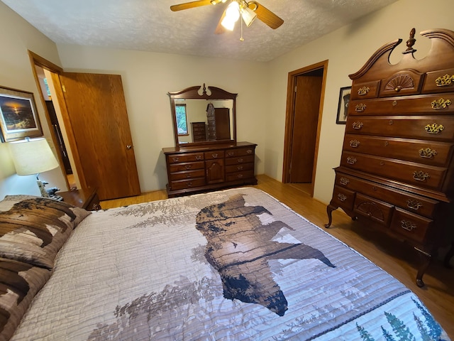 1514 Opal Lake Rd, Gaylord, MI 49735 - bedroom featuring a textured ceiling, ceiling fan, and wood finished floors