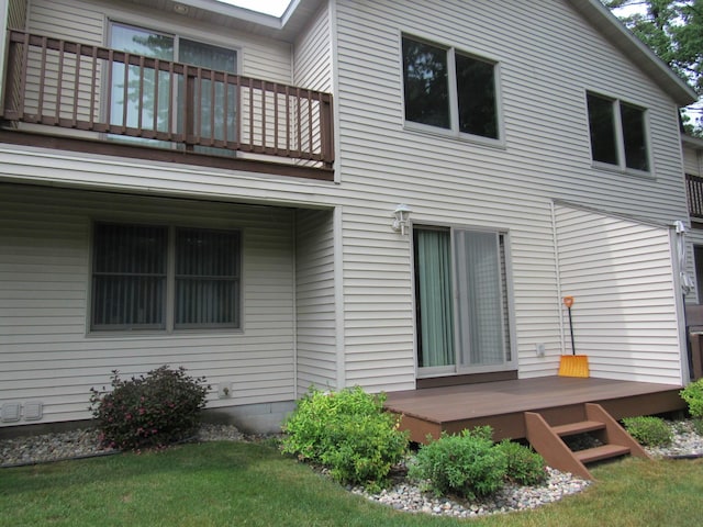201 White Deer Trl, Prudenville, MI 48651 - back of property featuring a balcony, a deck, and a lawn