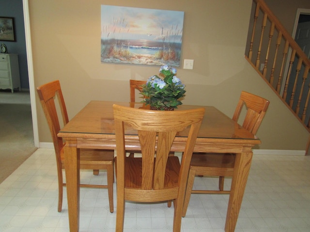 201 White Deer Trl, Prudenville, MI 48651 - dining area featuring stairs and tile patterned floors