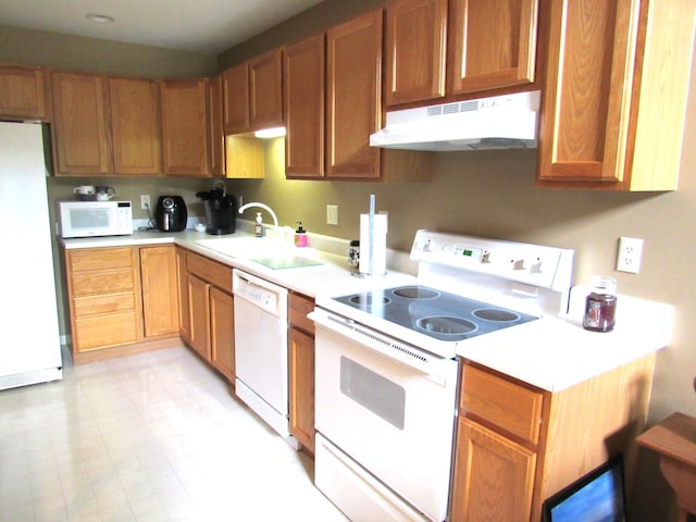 201 White Deer Trl, Prudenville, MI 48651 - kitchen featuring under cabinet range hood, white appliances, light countertops, and brown cabinets