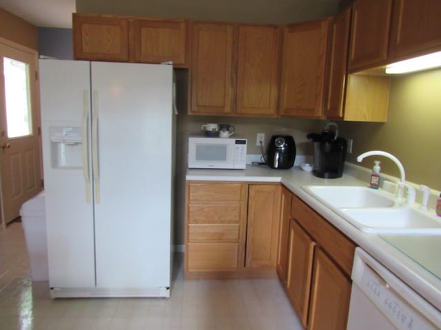 201 White Deer Trl, Prudenville, MI 48651 - kitchen featuring white appliances, light countertops, and brown cabinetry