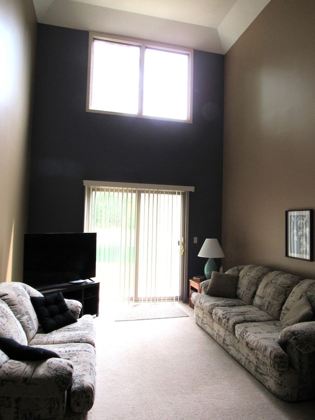201 White Deer Trl, Prudenville, MI 48651 - carpeted living room with healthy amount of natural light and a towering ceiling