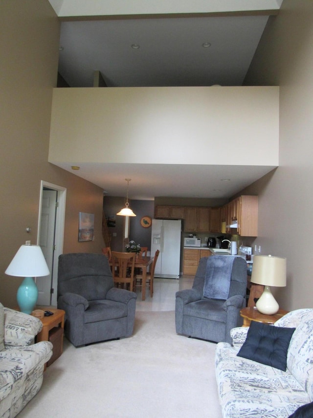 201 White Deer Trl, Prudenville, MI 48651 - living room featuring a towering ceiling and light colored carpet