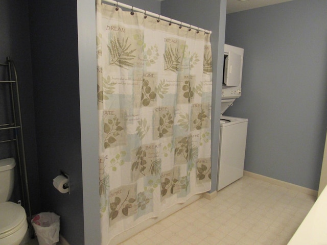 201 White Deer Trl, Prudenville, MI 48651 - bathroom featuring estacked washer and dryer and curtained shower