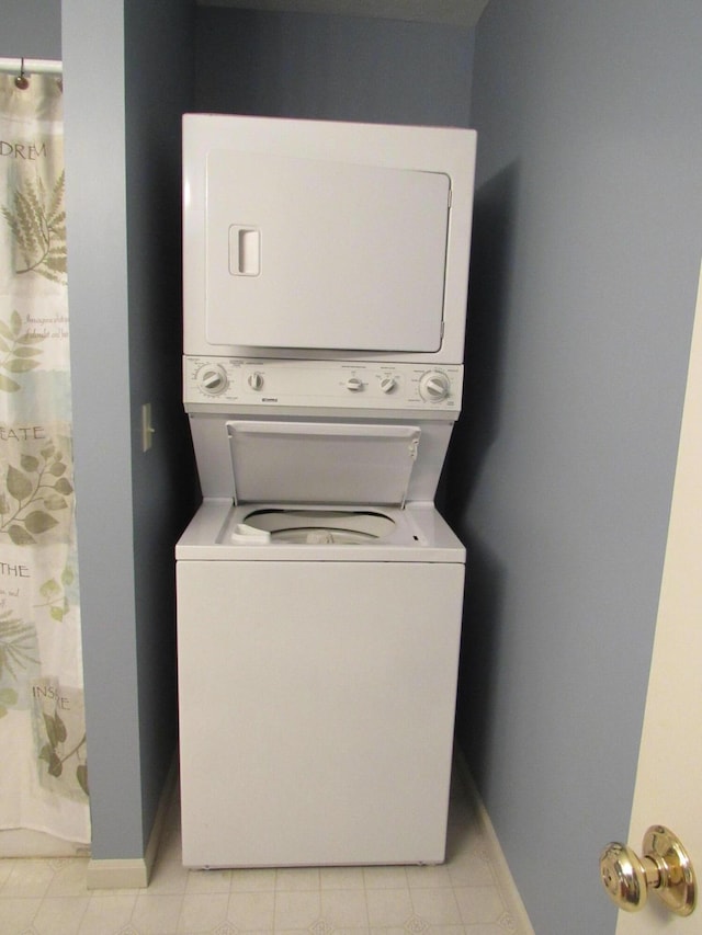 201 White Deer Trl, Prudenville, MI 48651 - laundry room with stacked washer and clothes dryer and light tile patterned flooring