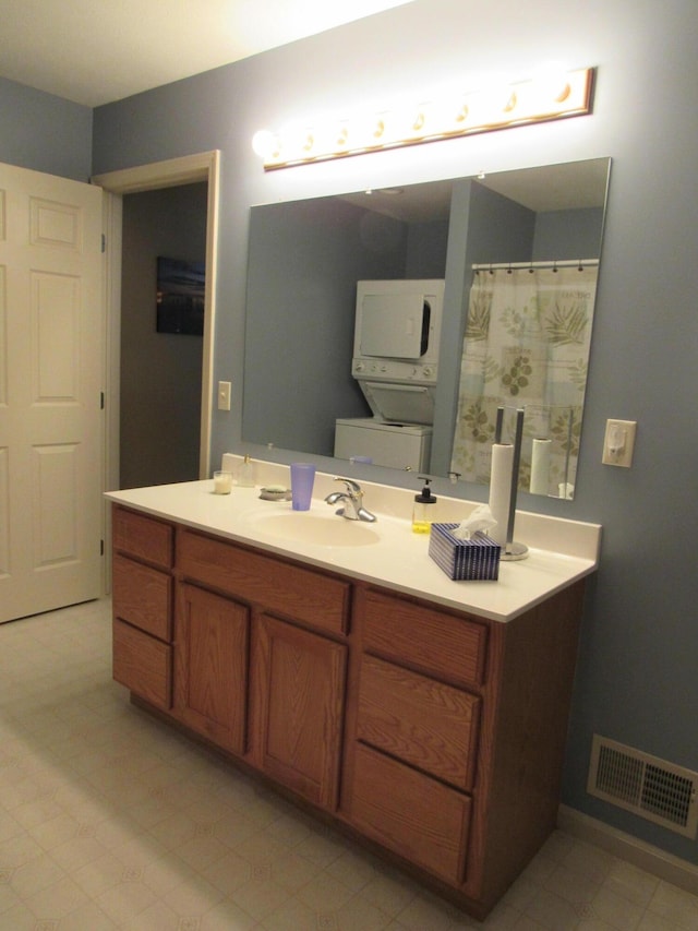 201 White Deer Trl, Prudenville, MI 48651 - bathroom with stacked washer and clothes dryer and vanity