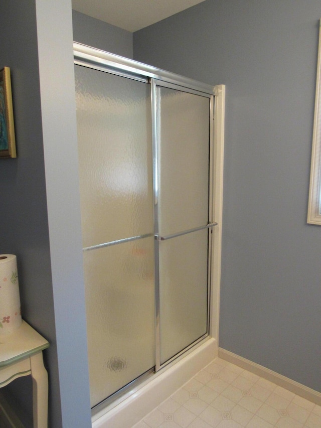 201 White Deer Trl, Prudenville, MI 48651 - full bathroom featuring a shower stall and tile patterned floors