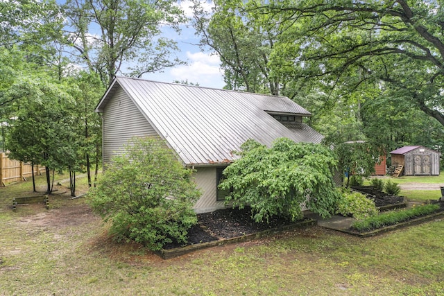 1655 Arrowhead Trl, West Branch, MI 48661 - view of property exterior featuring a storage unit and a metal roof