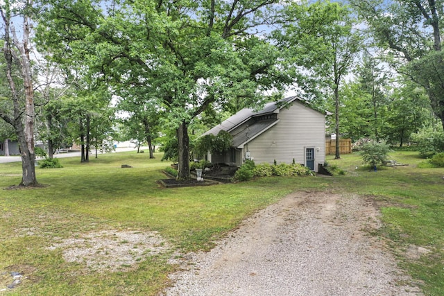 1655 Arrowhead Trl, West Branch, MI 48661 - view of side of property with a lawn and driveway