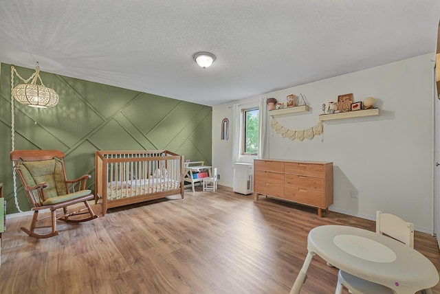 1655 Arrowhead Trl, West Branch, MI 48661 - bedroom with wood finished floors and a textured ceiling