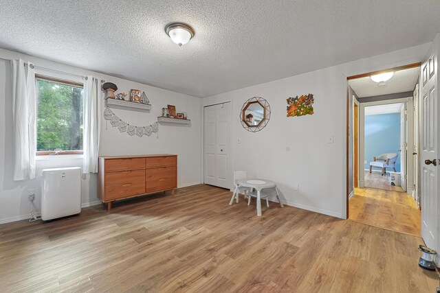 1655 Arrowhead Trl, West Branch, MI 48661 - empty room with light wood finished floors and a textured ceiling