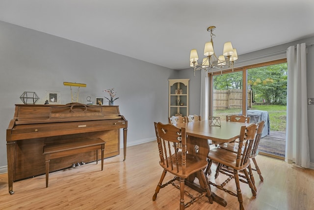 1655 Arrowhead Trl, West Branch, MI 48661 - dining room with a chandelier and light wood-style floors