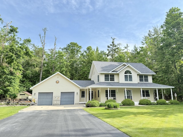 2176 Deepwoods Dr, Gaylord, MI 49735 - view of front of house with asphalt driveway, a shingled roof, a front yard, an attached garage, and a porch