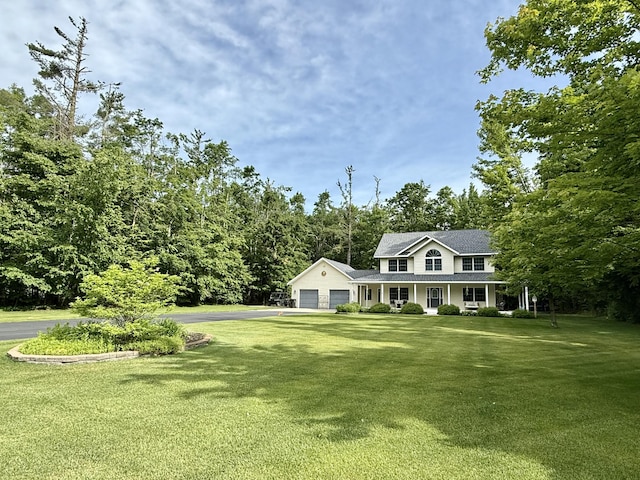 2176 Deepwoods Dr, Gaylord, MI 49735 - view of front of house with covered porch, a front yard, and driveway