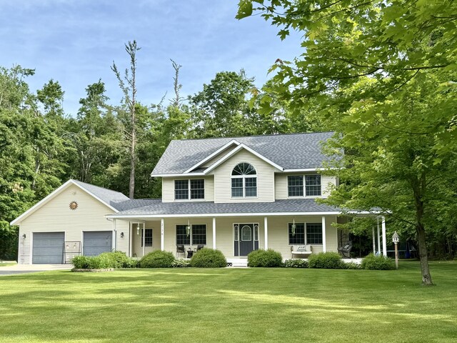 2176 Deepwoods Dr, Gaylord, MI 49735 - view of front facade featuring a porch, roof with shingles, and a front yard