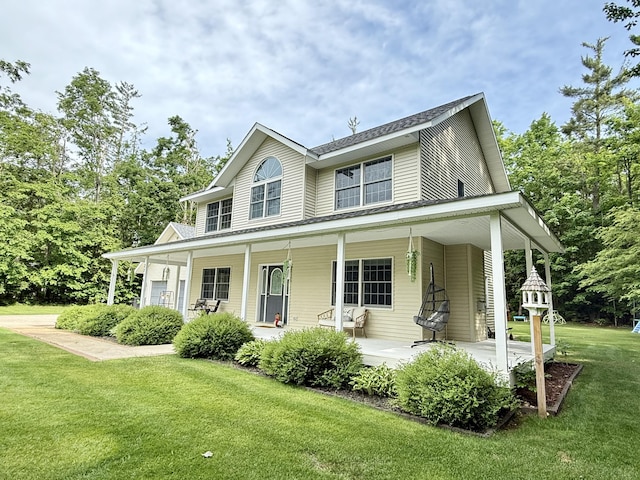 2176 Deepwoods Dr, Gaylord, MI 49735 - farmhouse inspired home featuring a porch and a front lawn