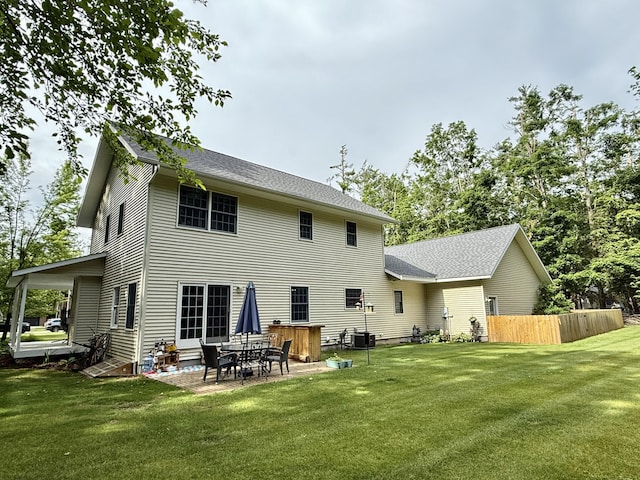2176 Deepwoods Dr, Gaylord, MI 49735 - back of house with a patio and roof with shingles