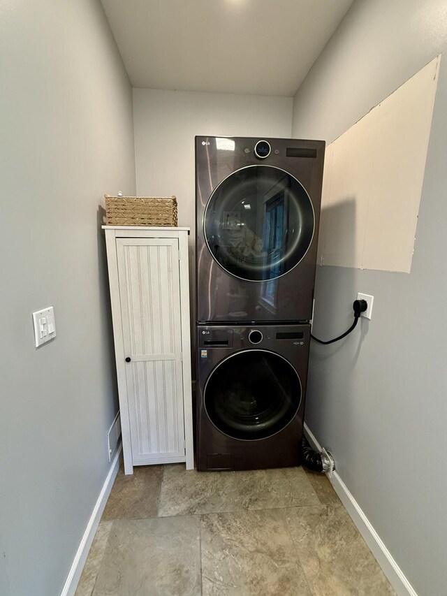 2176 Deepwoods Dr, Gaylord, MI 49735 - washroom featuring stacked washer and clothes dryer and baseboards