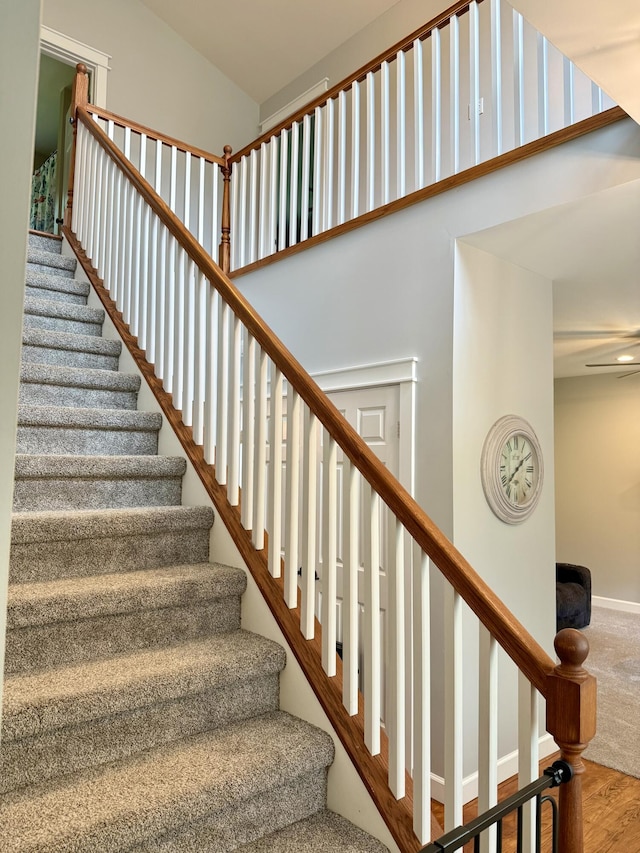 2176 Deepwoods Dr, Gaylord, MI 49735 - stairs with a towering ceiling and wood finished floors
