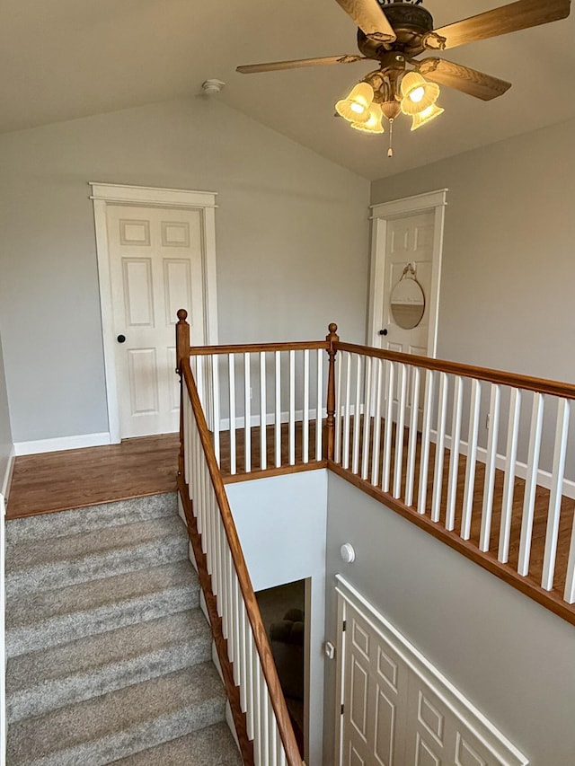 2176 Deepwoods Dr, Gaylord, MI 49735 - stairs with ceiling fan, vaulted ceiling, and wood finished floors