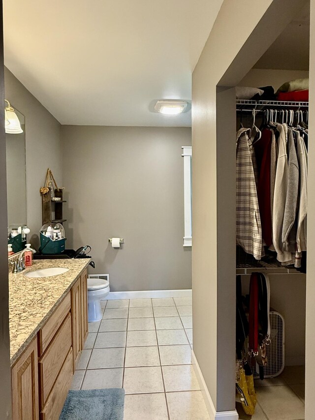 2176 Deepwoods Dr, Gaylord, MI 49735 - bathroom featuring vanity, tile patterned flooring, and a spacious closet