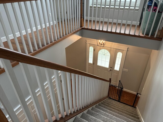 2176 Deepwoods Dr, Gaylord, MI 49735 - stairs with a chandelier and a high ceiling