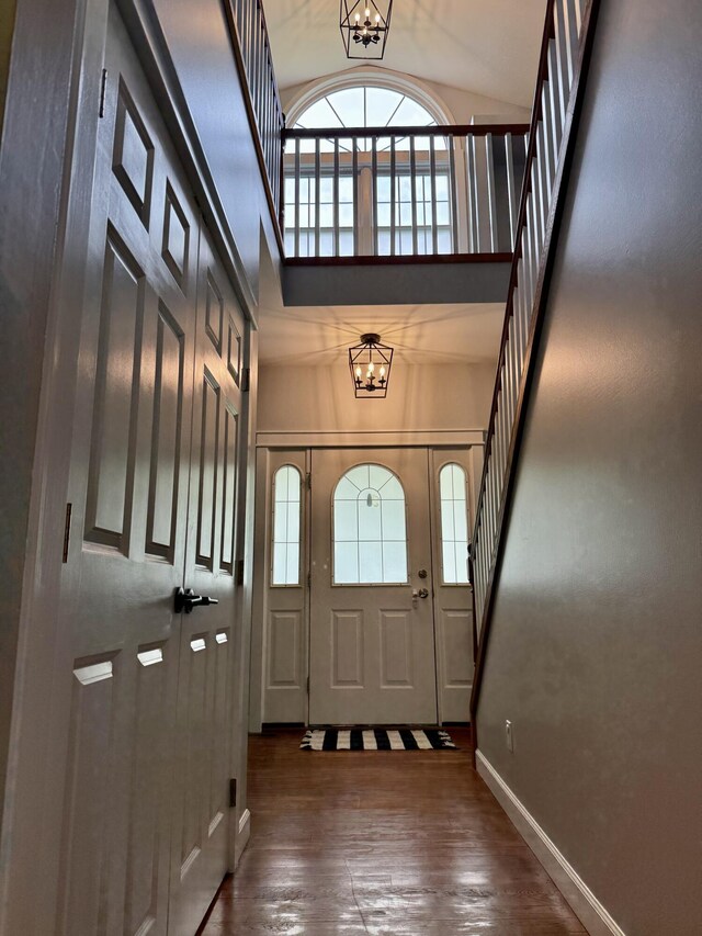 2176 Deepwoods Dr, Gaylord, MI 49735 - foyer entrance with a chandelier, a high ceiling, wood finished floors, and stairs